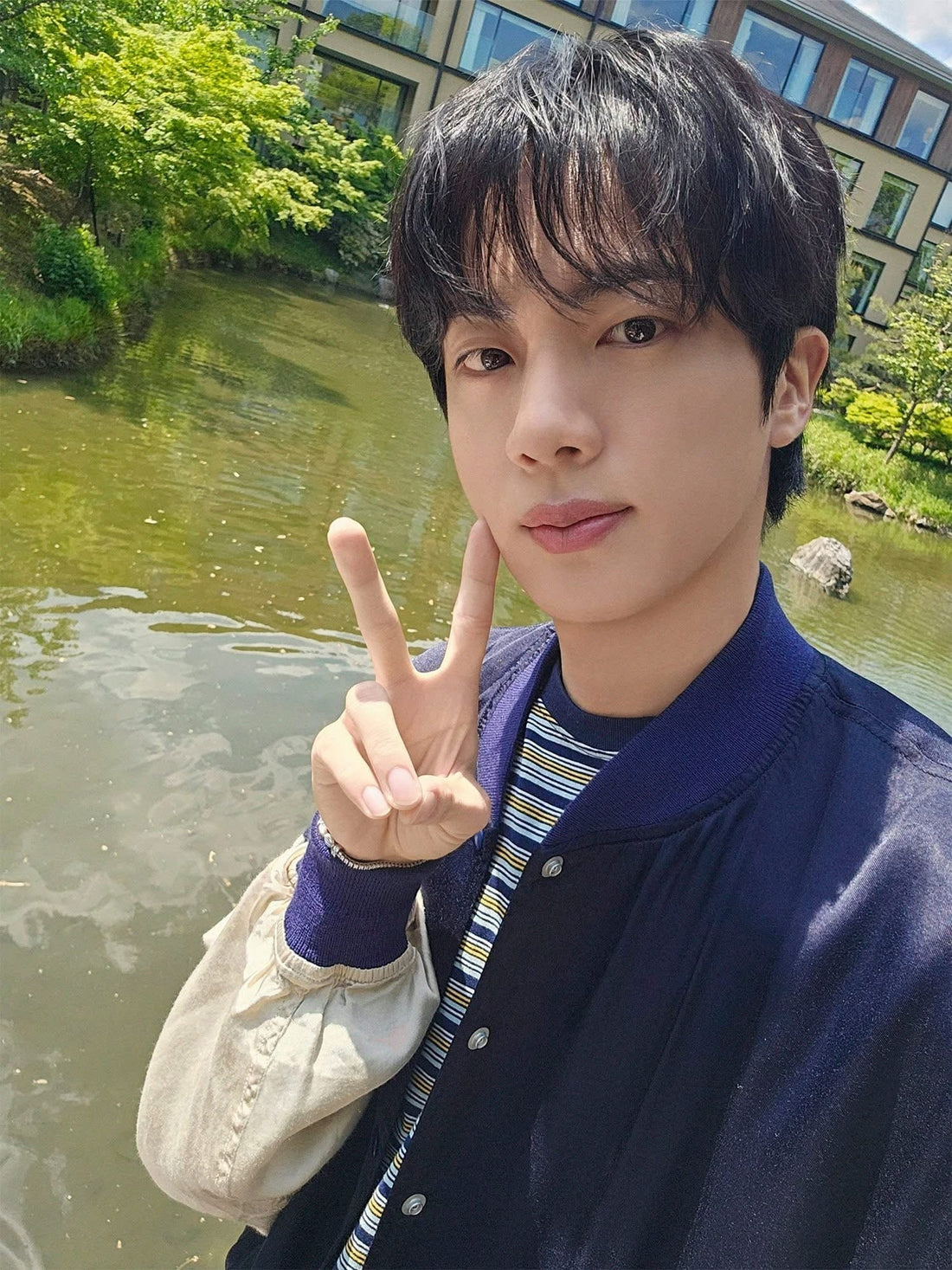 BTS Jin wore a BY (Stripe T-shirt Multi).